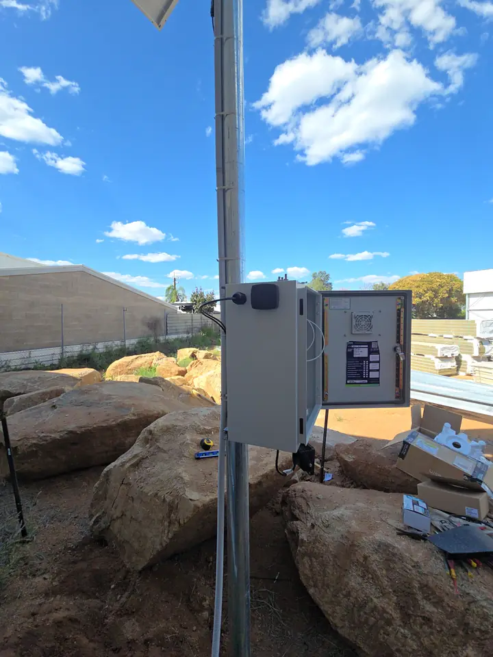 The control cabinet fitted to the pole with its door open