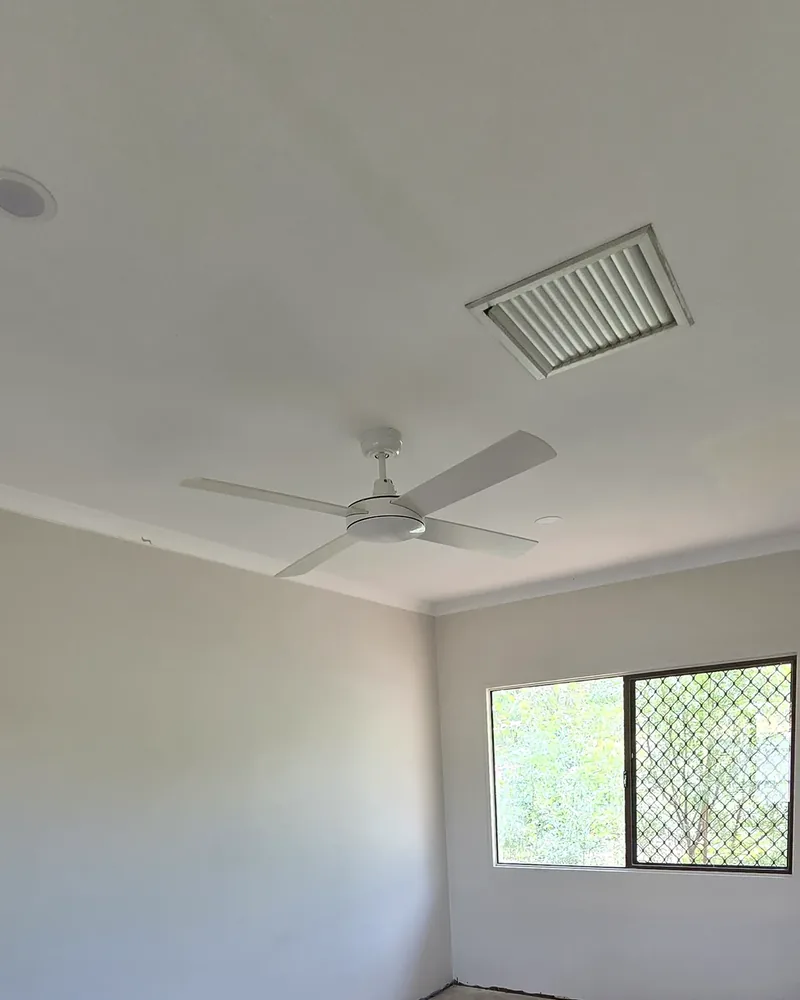 Electrician fitting off a ceiling fan in an Alice Springs home