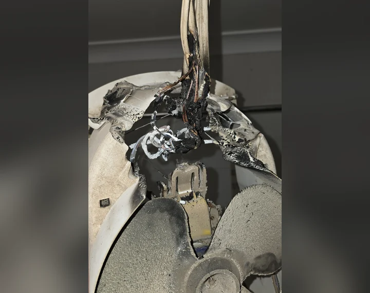 What we found: burnt wiring and a heat-damaged fan housing inside the old unit