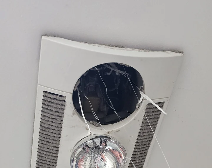 Before: the old bathroom heat lamp and exhaust unit in the ceiling