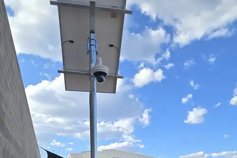 A solar-powered pole with a PTZ security camera under its solar panel, installed by Sawtell Contracting NT in Alice Springs