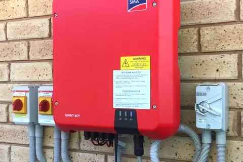 An SMA Sunny Boy solar inverter installed on a brick wall by Sawtell Contracting NT