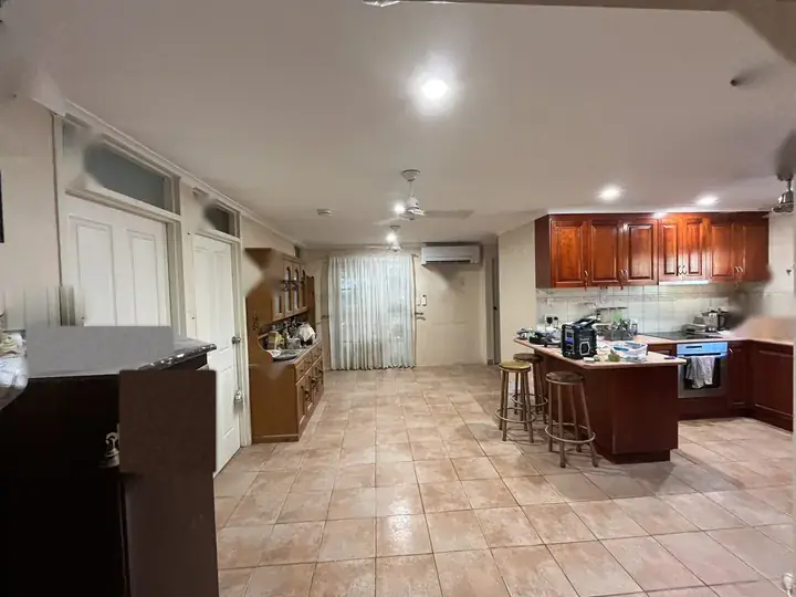 After: the finished kitchen and living area, with a new ceiling, fans and lights