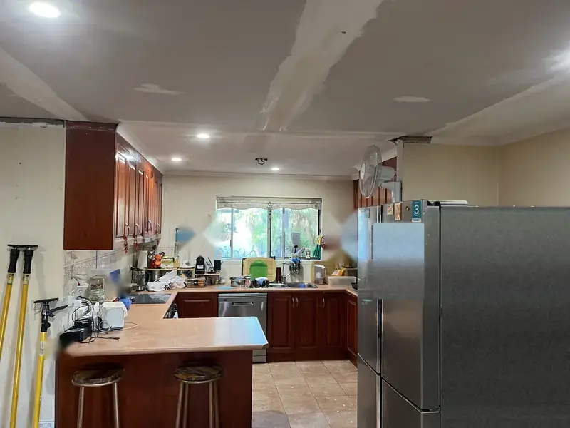 New ceiling sheets fixed up in the kitchen, with the joins visible and the first lights in